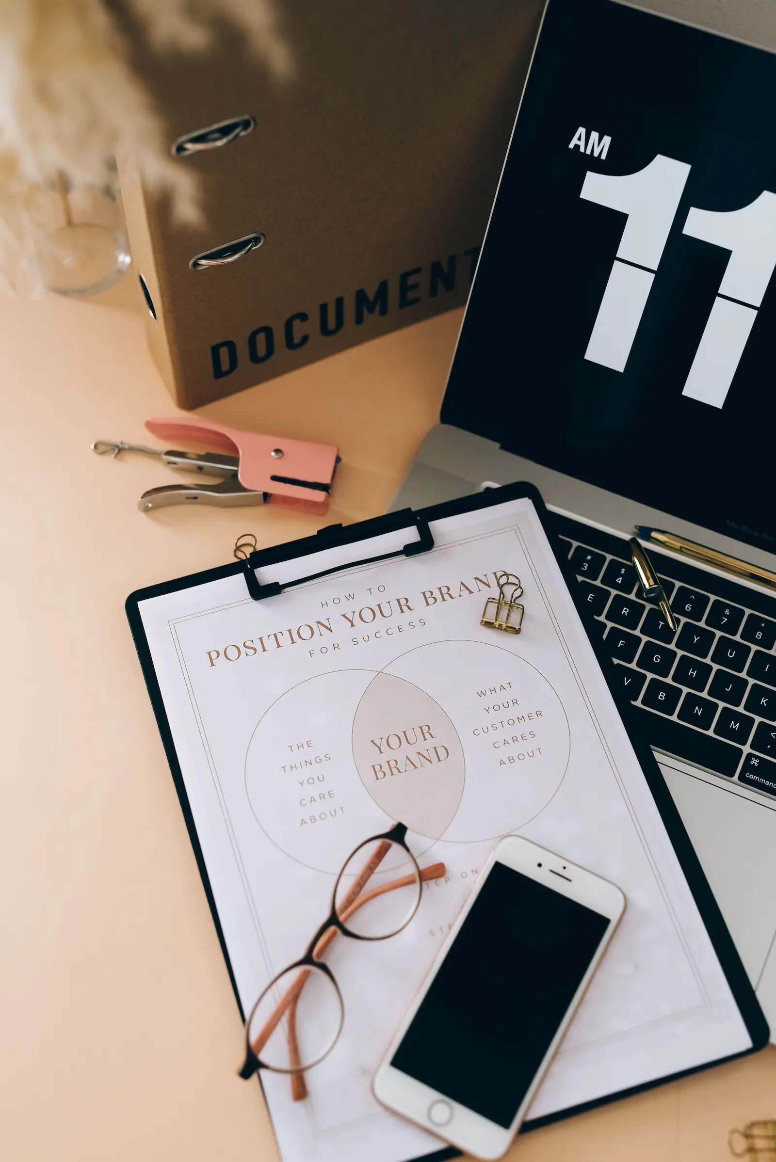 Laptop and brand worksheet on a desk